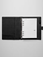 Image shows the January dashboard used in a black leather A5 ring-bound planner.