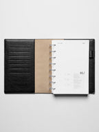 Image shows the January dashboard used in a black leather Half Letter disc-bound planner.