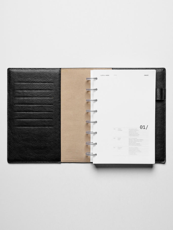 Image shows the January dashboard used in a black leather Half Letter disc-bound planner.