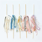 Decorative sticks with colorful fabric ends on a white background