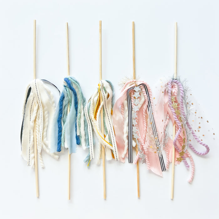 Decorative sticks with colorful fabric ends on a white background
