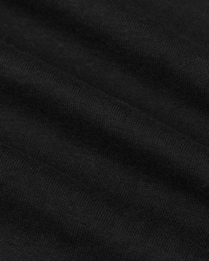 Black knit fabric close-up of the All Black Tall Classic Polo.