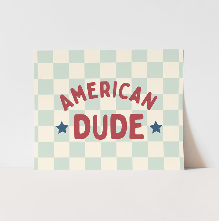 Checkered pillow with 'American Dude' text and stars on a light background