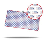 The ASSMAN - Towel displays a repeated pattern of New York “ASSMAN” license plates in red and blue with a red border. It includes a black cord, handy clip, eyelet for easy hanging or storage, and features a circular close-up inset.