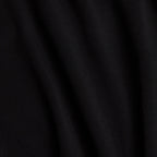 Close-up of the Black - Q-Zip’s soft, matte fabric shows gentle folds and subtle shadows. The smooth surface features moisture-wicking properties, with light accentuating raised areas and deepening the rippled black creases.