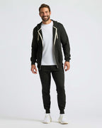 Man wearing Black Fleece French Terry Zip Hoodie, joggers, and sneakers.