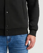 Black Fleece Bomber Jacket with snap-buttons and ribbed cuffs, paired with jeans.