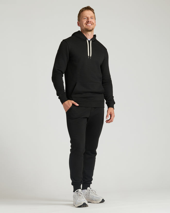 Man wearing Black Tall Fleece French Terry Pullover Hoodie.