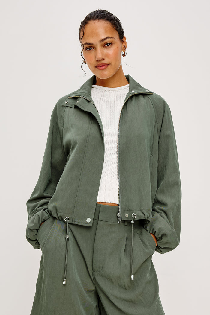 Black Jacket With Oversized Relaxed Fit High Funnel Neck Dropped Shoulders Long Sleeves Center-Front Ties Side-Seam Zipper in Ivy Colorway - Upper Body Back View Featured on Model