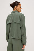 Black Jacket With Oversized Relaxed Fit High Funnel Neck Dropped Shoulders Long Sleeves Center-Front Ties Side-Seam Zipper in Ivy Colorway - Full Body Front View Featured on Model