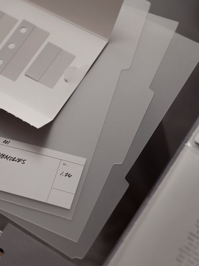 Set of three matte transparent blank side tab dividers with blank white labels shown against a dark background.