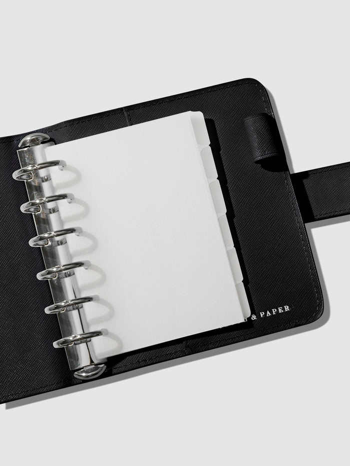 Dividers in use inside a black leather agenda.