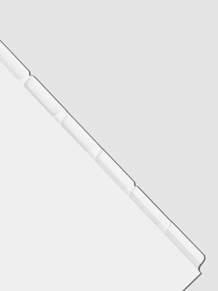 Closeup of blank divider tabs on a neutral background.