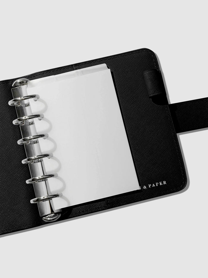 Dividers in use inside a black leather agenda.