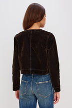 Capistrano Cropped Jacket in Chocolate Velvet Flocked Denim With Crew Neckline, Indigo Wash, Front Buttons, Buttoned Chest Pockets, and Long Sleeves in Chocolate Flocking Colorway - Upper Body Back View Featured on Model