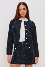 Capistrano Cropped Jacket in Denim Tweed Texture With Crew Neckline, Front Buttons, Buttoned Chest Pockets, and Long Sleeves in Denim Tweed Colorway - Upper Body Front View Featured on Model
