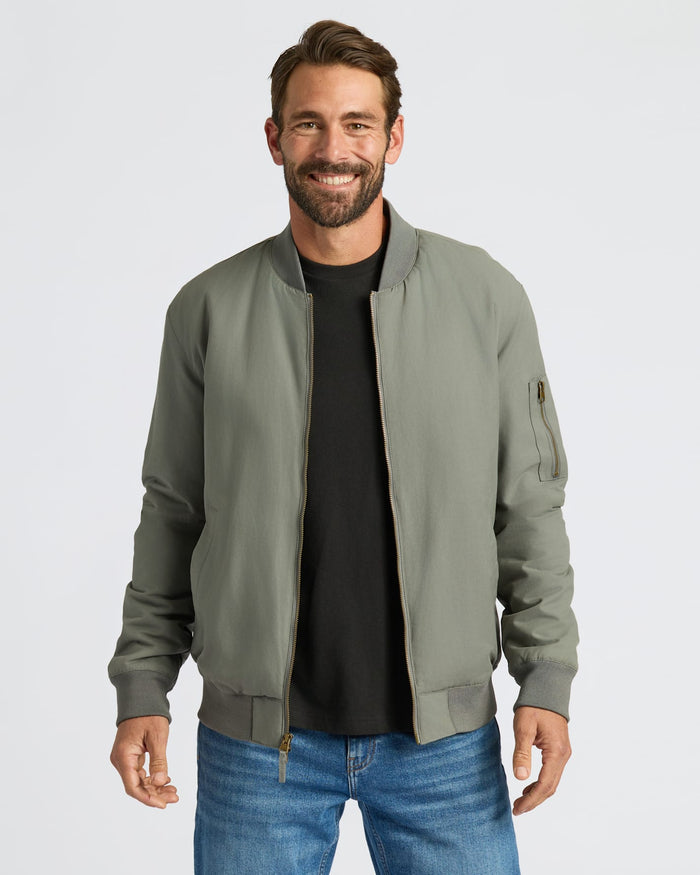 Man wearing Carbon Bomber Jacket with front zip and sleeve pocket.