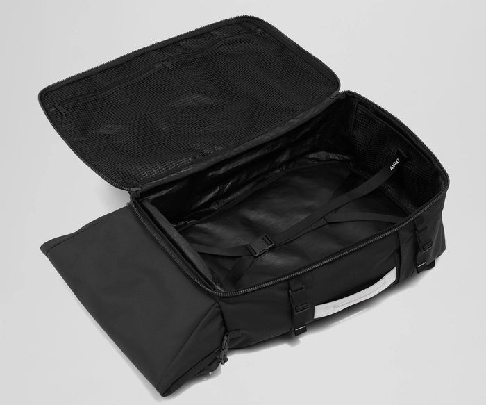 Open, unpacked Carry-On Boot Bag 55L showing the mesh zipper pockets and compression straps