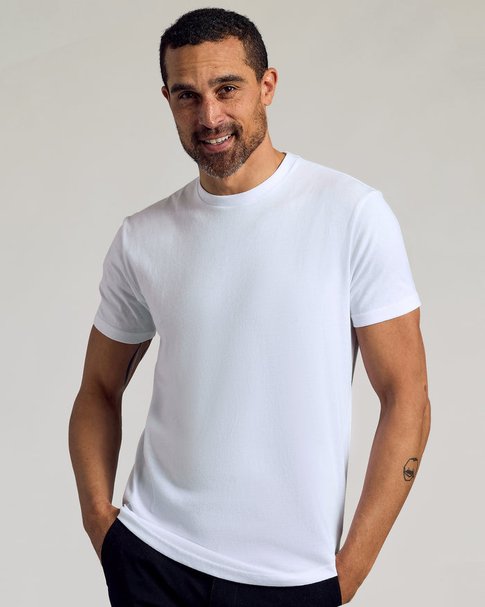 Man wearing All White Curved Hem Classic Crew Neck T-shirt.