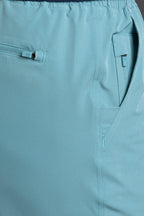 Close-up of light blue pants with a brand label on a matching background || Underseas