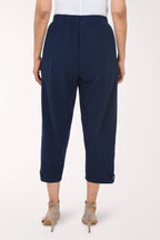 Navy blue pants worn by a person on a white background