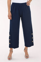 Navy blue pants with gold buttons on a white background