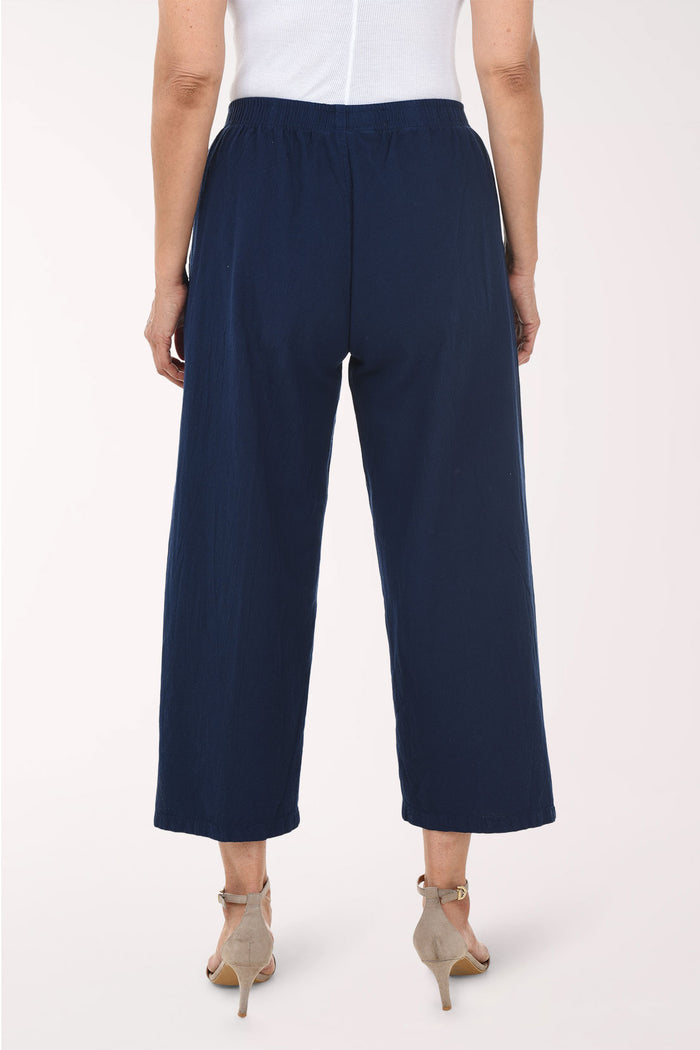 Navy blue pants with gold buttons on a white background