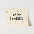 Card with 'Cue the Confetti' text and confetti illustrations on a beige background