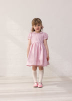 Girl in a light red dress with stripes