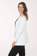 Woman wearing a white cardigan over a black top on a white background