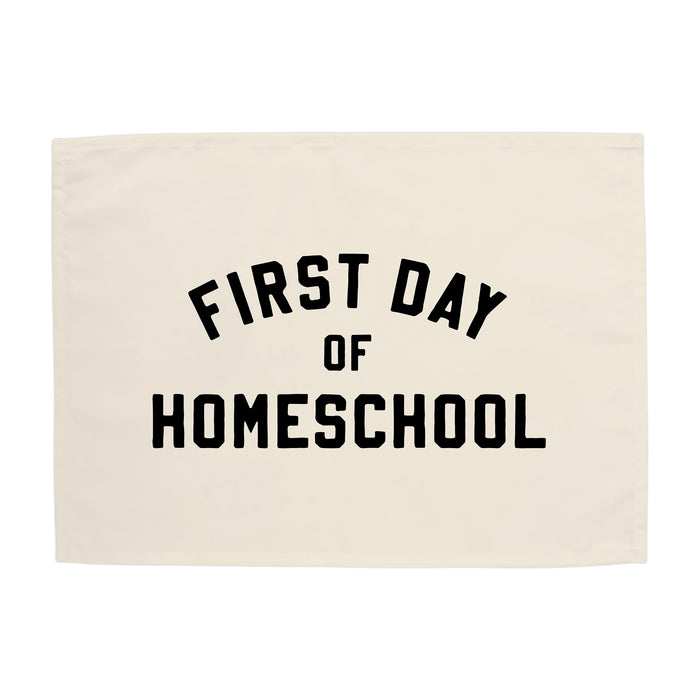 Beige cloth with 'First Day of Homeschool' text on a white background