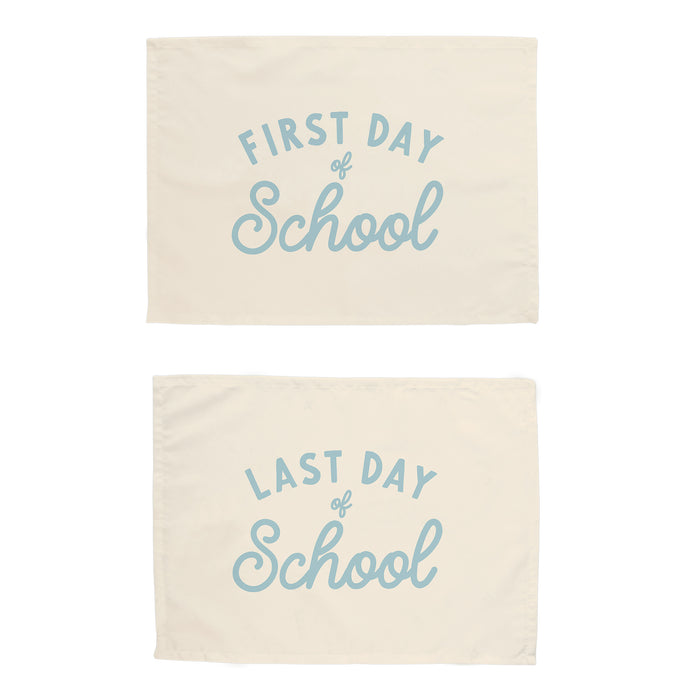 Two cream-colored bags with blue text 'First Day of School' and 'Last Day of School' on a white background.