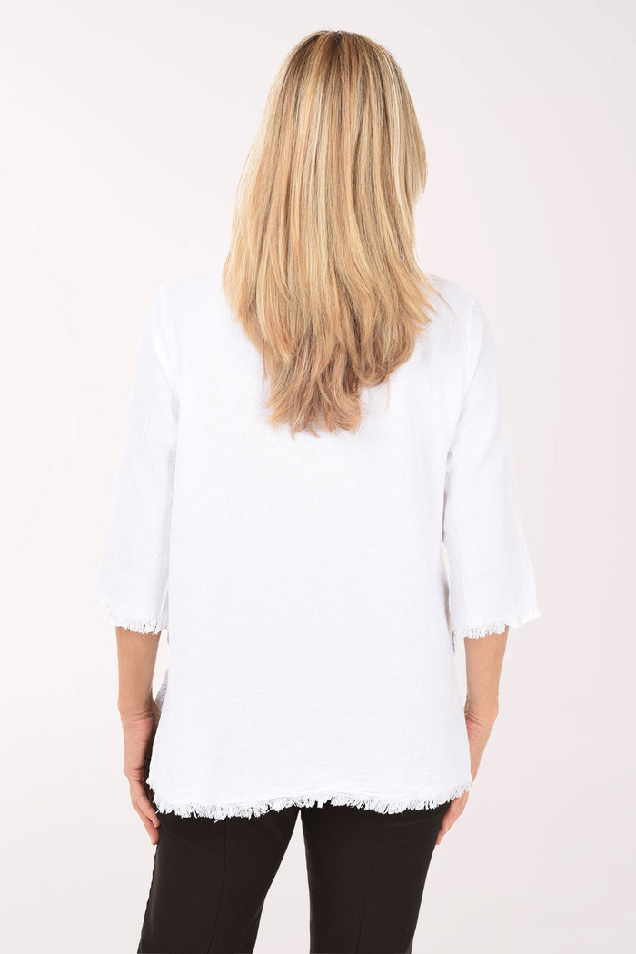 Woman wearing a white sweater and black pants on a white background