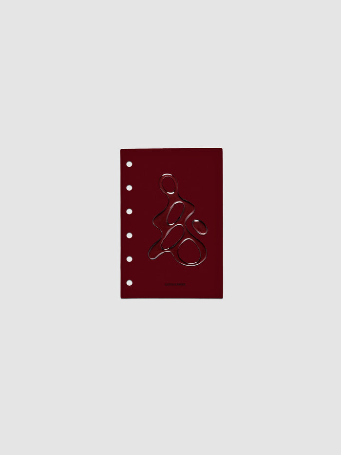 Dark red, semi-transparent, and glossy plastic planner dashboard with organic raised shape design in size Pocket on a neutral background.