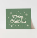 Green Christmas card with 'Merry Christmas' text and snowflakes on a white background