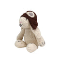 Knitted bunny toy wearing a brown hat on a white background