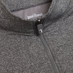 Close-up of the Heather Gray - Q-Zip, an athletic-fit jacket featuring a centrally placed zipper with a golf club logo pull tab. BOGEY BROS is printed in white on the gray inner collar lining.