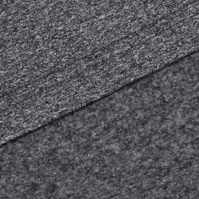 Close-up of two overlapping layers from the Heather Gray - Q-Zip: a smooth, moisture-wicking heathered gray knit on top and a soft, dark gray fleece beneath, showcasing the contrasting textures of each material.