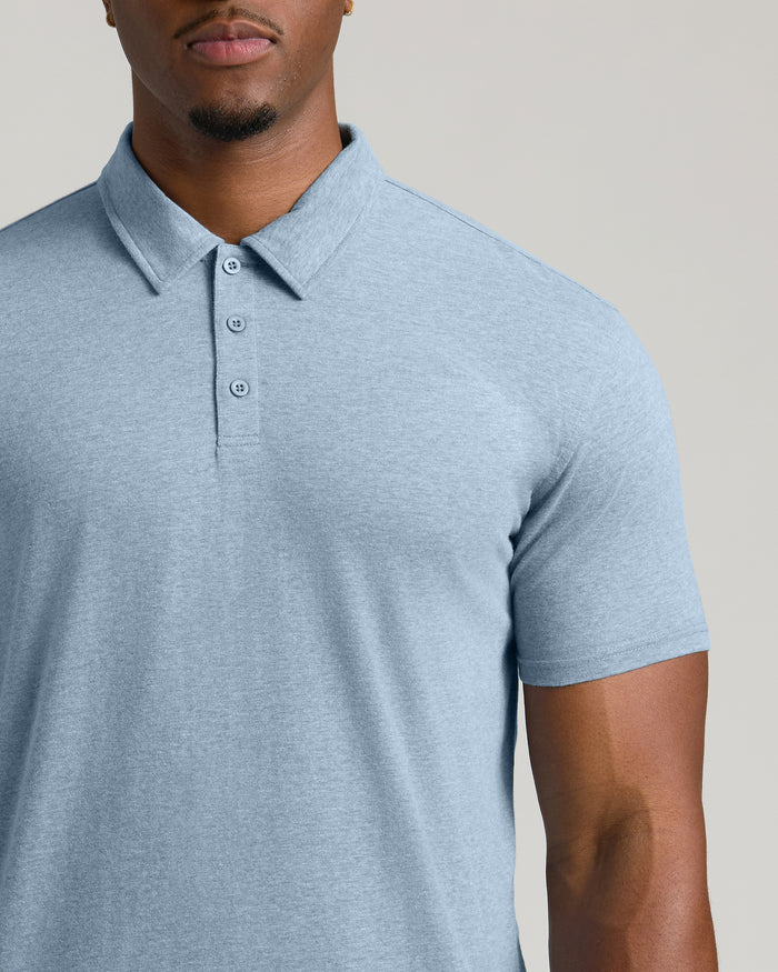 Man wearing Heather Indigo Short Sleeve Tall Polo with three-button placket.