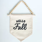 Fabric banner with 'Hello Fall' text and wooden beads on a white background