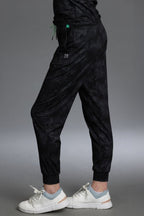 Black jogger pants worn by a person on a gray background || Black Camo