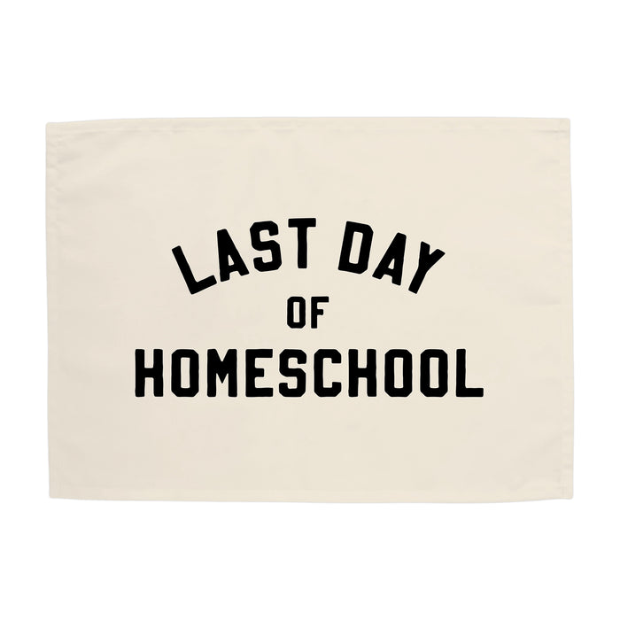 Beige towel with 'Last Day of Homeschool' text on a white background