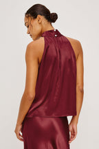 Leah Halter Top in Satin Crepe With a High Neckline, Sleevleless Cut, Back Button Neck Closure in Garnet Colorway - Upper Body Back View Featured on Model