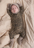 Leopard print jumpsuit with hood and gray ribbed edges, full-length legs and feet.