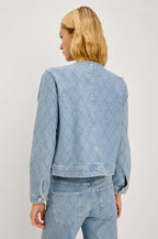 Lido Lady Jacket in Light Stretch Denim With Cropped Boxy Fit, Collarless Neckline, Front Buttons, Long Sleeves, and Chest Patch Pockets in Quilted Stud Colorway - Upper Body Back View Featured on Model