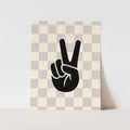 Framed artwork with a black hand making a peace sign on a checkered background