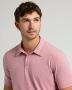 Young man wearing Light Heather Boysenberry Short Sleeve Tall Polo.