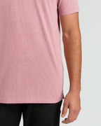 Midsection wearing Light Heather Boysenberry Short Sleeve Tall Polo and black pants.