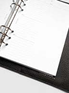 Close up of Mental Download inserts inside discbound planner and leather cover.