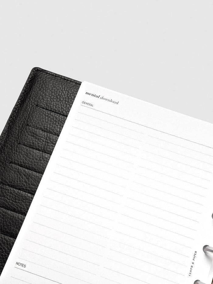 Close up of Mental Download inserts inside discbound planner and leather cover.